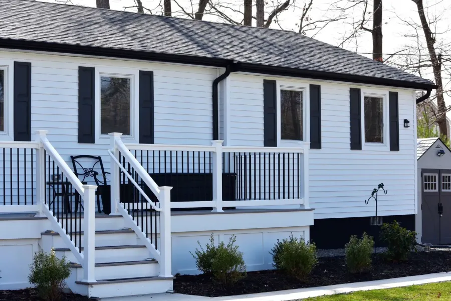 White home with black shutters, vinyl deck and black seamless gutters in Galloway, NJ