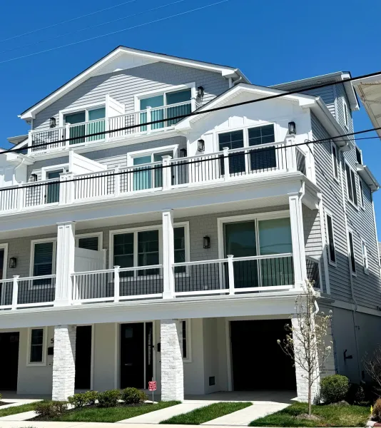 Modern navy and white home with wood soffit gable and white downspout in Ventnor, NJ