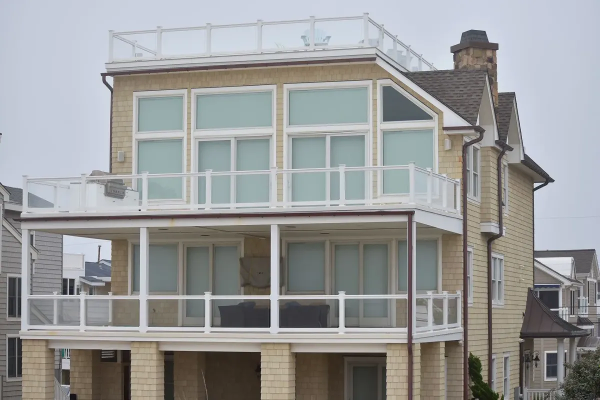 Bronze seamless gutters along the decks of a multi-level shingle beach house in Sicklerville, NJ