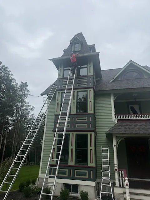 Apex Gutters crew on ladders installing gutters on a Victorian tower in West Berlin, NJ