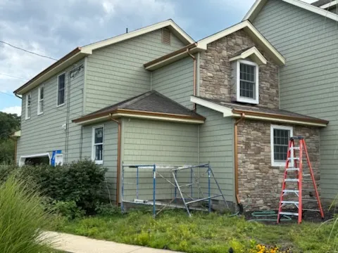 Seamless gutter installation on a sage siding and stone home in West Berlin, NJ
